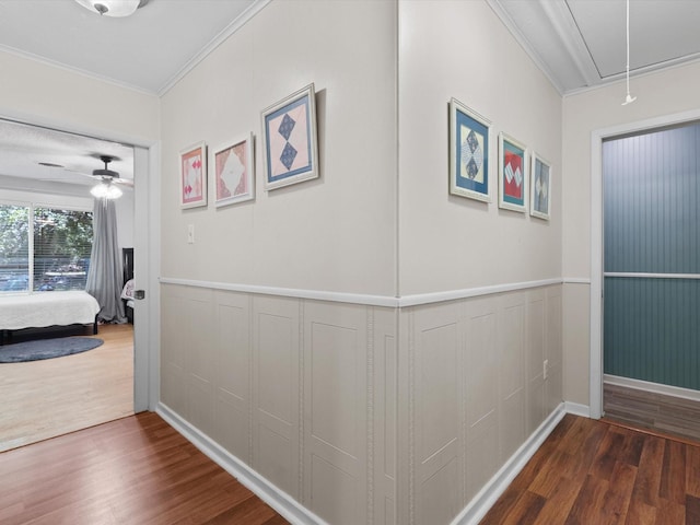 hallway featuring ornamental molding and dark hardwood / wood-style floors