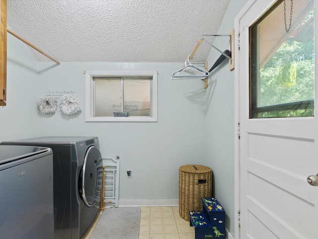 clothes washing area featuring washer and dryer and a textured ceiling