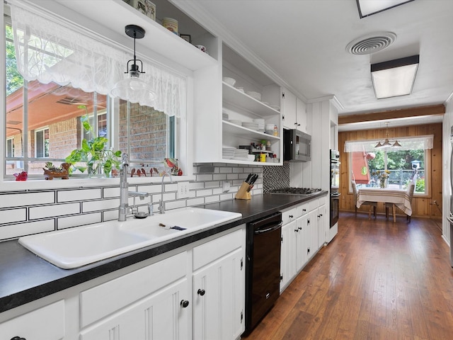 kitchen with sink, hanging light fixtures, dark hardwood / wood-style flooring, stainless steel appliances, and white cabinets