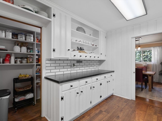 interior space featuring white cabinetry, dark hardwood / wood-style flooring, and tasteful backsplash