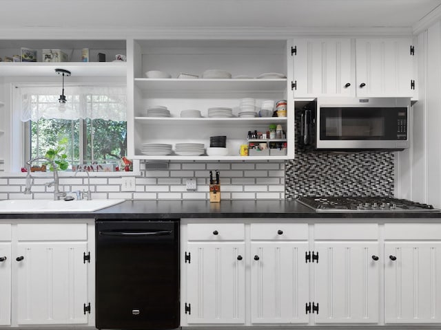 kitchen with tasteful backsplash, sink, white cabinets, hanging light fixtures, and stainless steel appliances