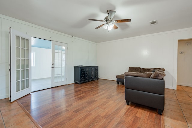 sitting room with hardwood / wood-style flooring, ceiling fan, and french doors