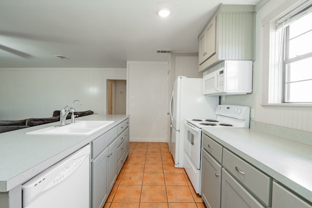 kitchen featuring white appliances, light tile patterned floors, sink, and gray cabinetry