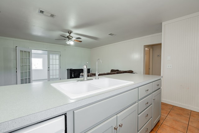 kitchen featuring french doors, sink, light tile patterned floors, dishwasher, and ceiling fan