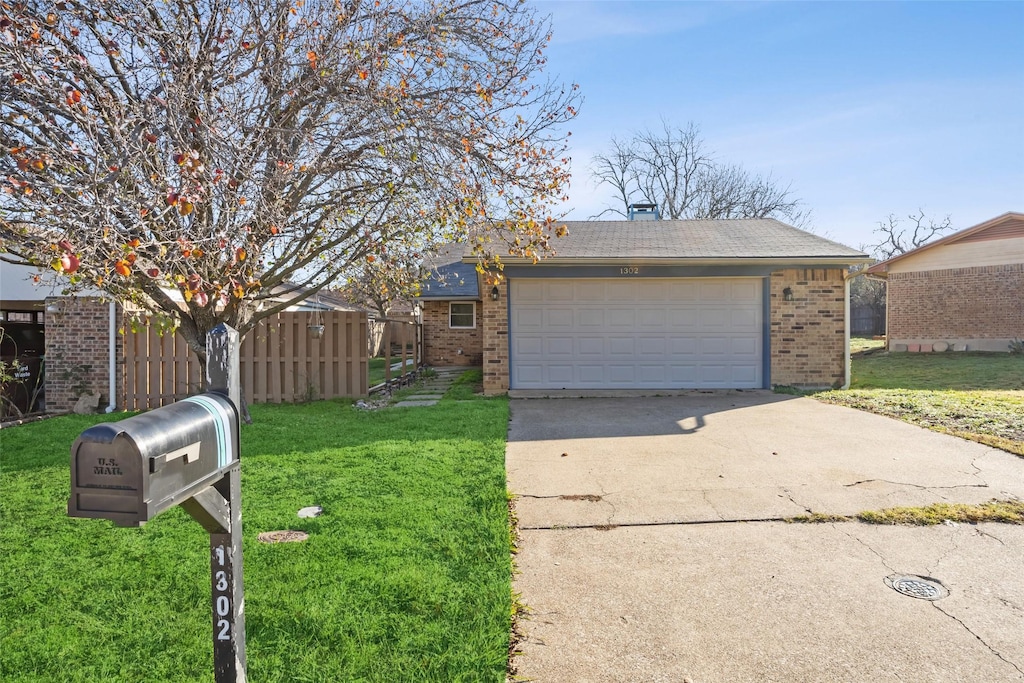 view of front of home with a front yard and a garage