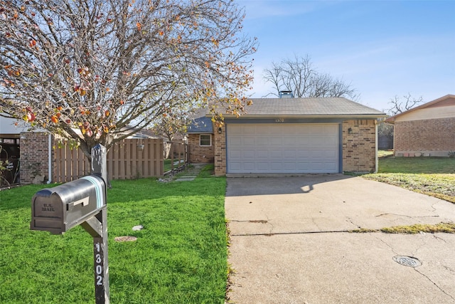 view of front of home with a front yard and a garage