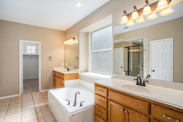 bathroom with tile patterned floors, vanity, and separate shower and tub