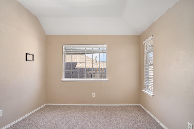 spare room with vaulted ceiling and carpet