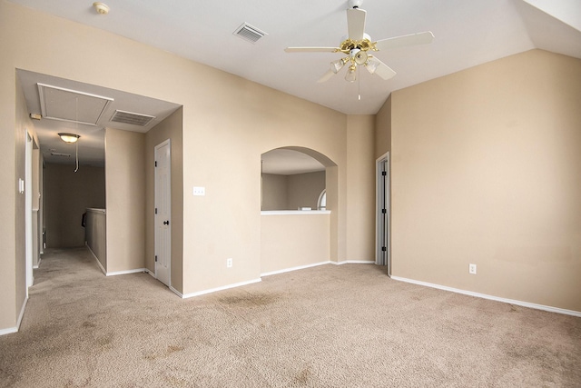 empty room with ceiling fan, light colored carpet, and vaulted ceiling