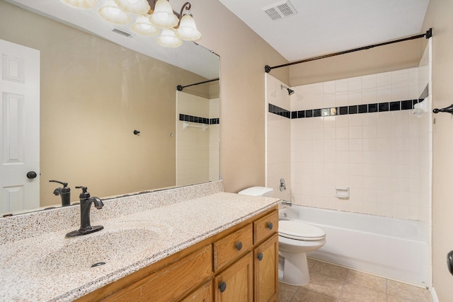 full bathroom featuring tiled shower / bath, vanity, and toilet