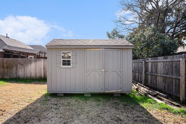 wooden deck featuring a lawn and a storage unit