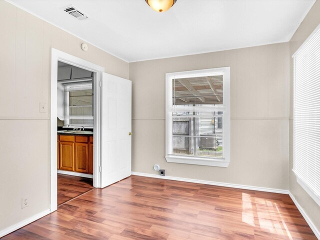 unfurnished room with hardwood / wood-style flooring and sink