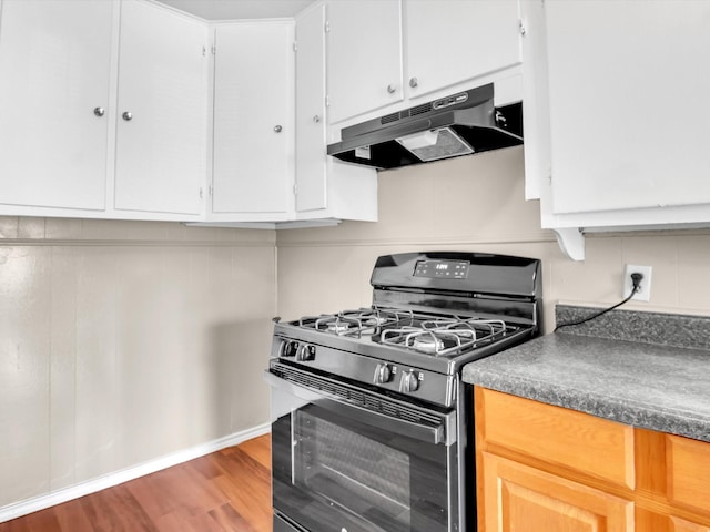 kitchen featuring hardwood / wood-style flooring, light brown cabinets, black gas stove, and white cabinetry