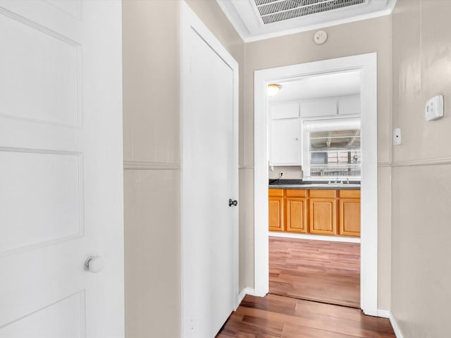 hall featuring dark hardwood / wood-style flooring and sink