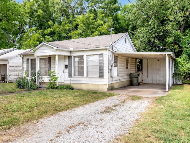 bungalow-style home featuring a carport and a front lawn