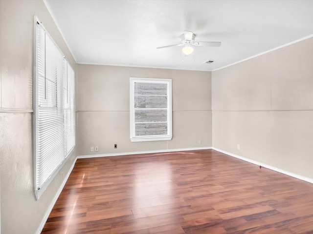 unfurnished room featuring dark hardwood / wood-style floors, ceiling fan, and a healthy amount of sunlight