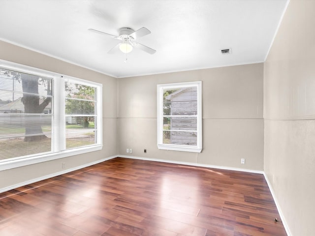 empty room featuring ceiling fan and dark wood-type flooring