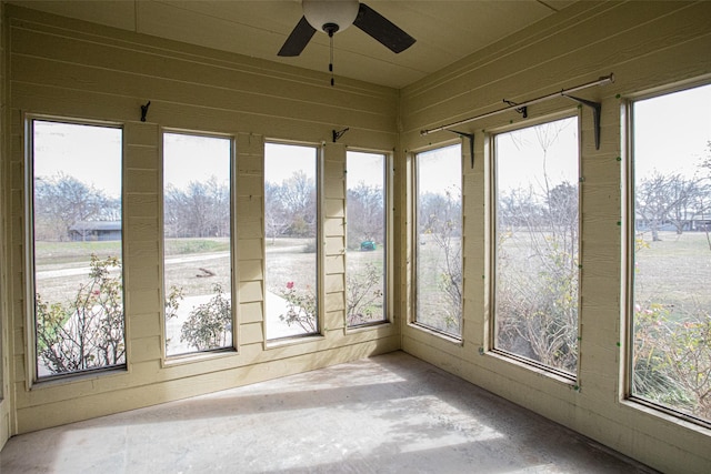 unfurnished sunroom with ceiling fan and a healthy amount of sunlight