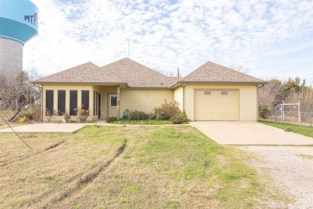 view of front of property with a garage and a front lawn