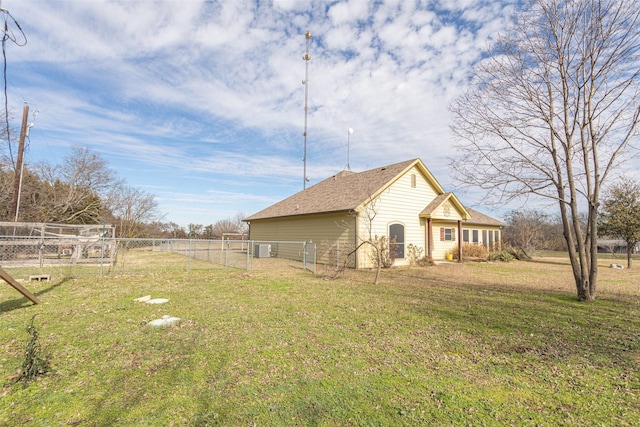 view of side of home featuring cooling unit and a lawn