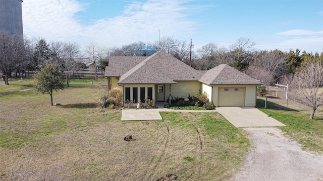 ranch-style home with a garage and a front yard