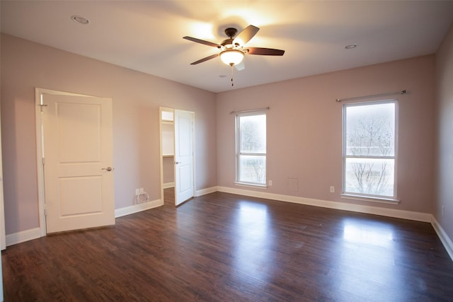 empty room featuring ceiling fan and dark hardwood / wood-style floors