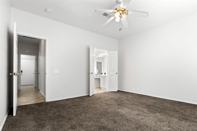 unfurnished bedroom featuring connected bathroom, ceiling fan, and carpet