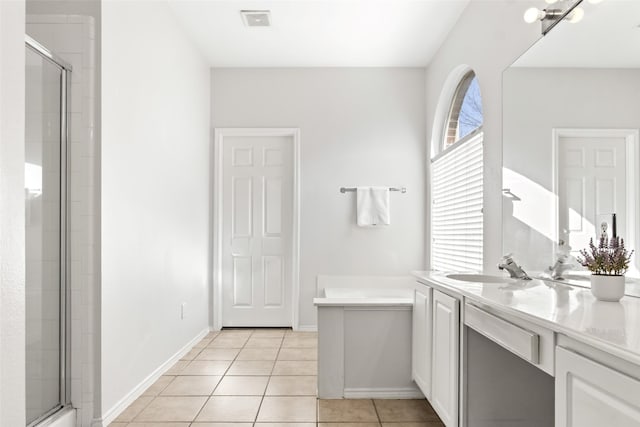 bathroom featuring vanity, tile patterned floors, and walk in shower