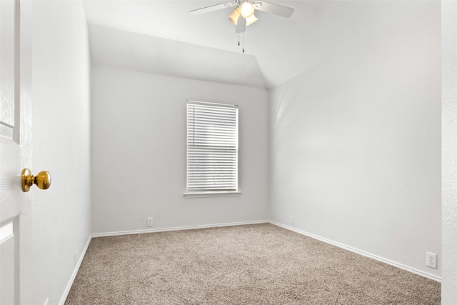 spare room with vaulted ceiling, ceiling fan, and carpet