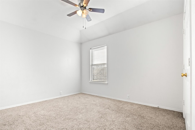 empty room featuring vaulted ceiling, carpet, and ceiling fan