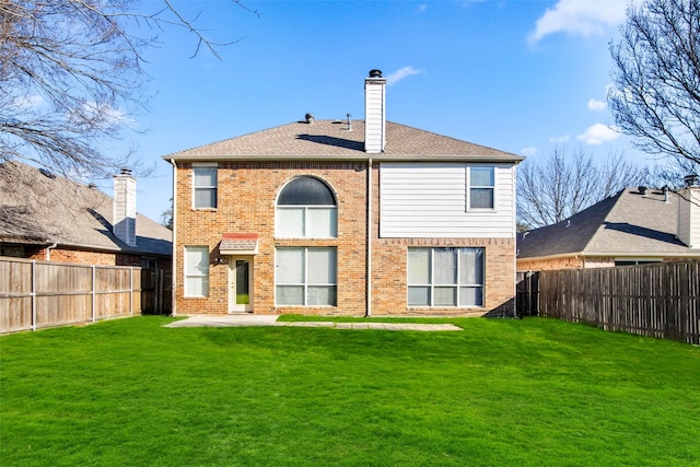 back of property with a yard and a patio