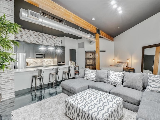 living room featuring a high ceiling and sink