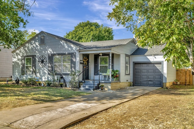 ranch-style house featuring covered porch, a garage, and a front lawn