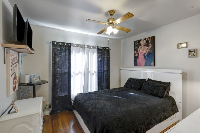 bedroom featuring ceiling fan and dark hardwood / wood-style flooring