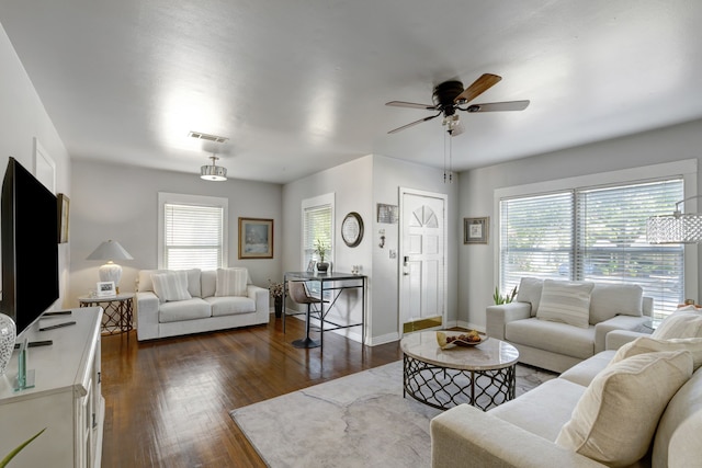 living room with plenty of natural light, ceiling fan, and dark hardwood / wood-style flooring