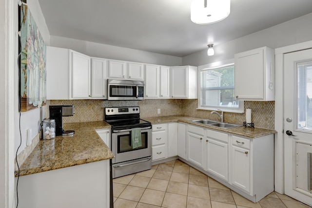 kitchen with white cabinets, light tile patterned flooring, sink, and appliances with stainless steel finishes