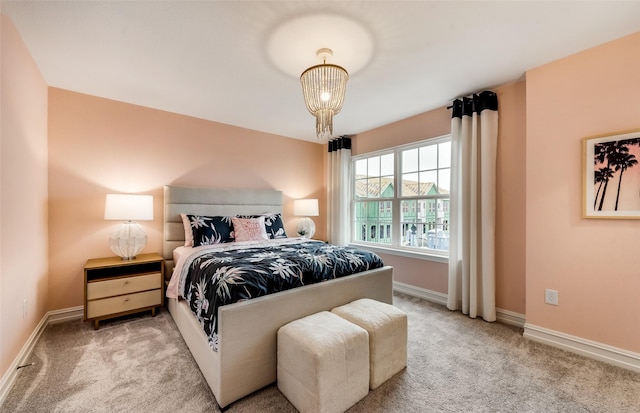 carpeted bedroom featuring a notable chandelier