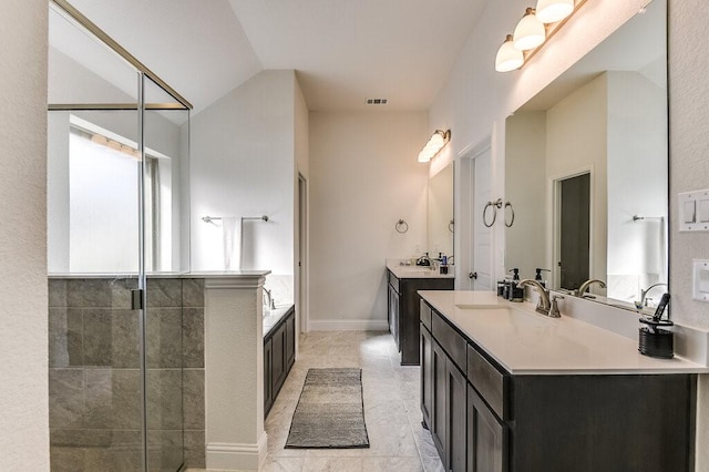 bathroom featuring vanity, lofted ceiling, and independent shower and bath