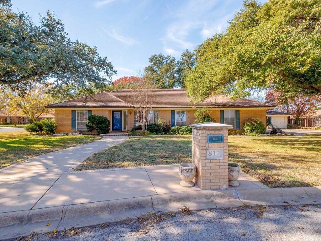 ranch-style home featuring a front yard