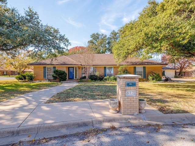 ranch-style home featuring a front yard