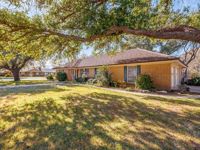 ranch-style house with a garage and a front yard