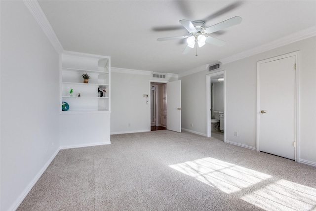 unfurnished bedroom with baseboards, ornamental molding, visible vents, and light colored carpet