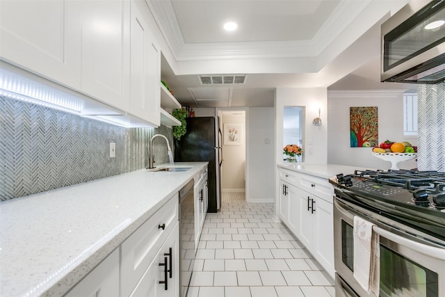 kitchen featuring light stone counters, sink, white cabinetry, and stainless steel appliances