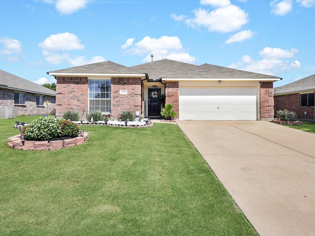 ranch-style home with a garage and a front lawn