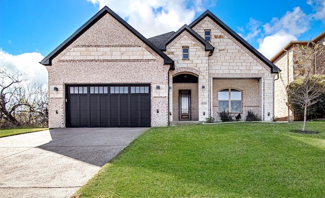 french provincial home featuring a front lawn and a garage