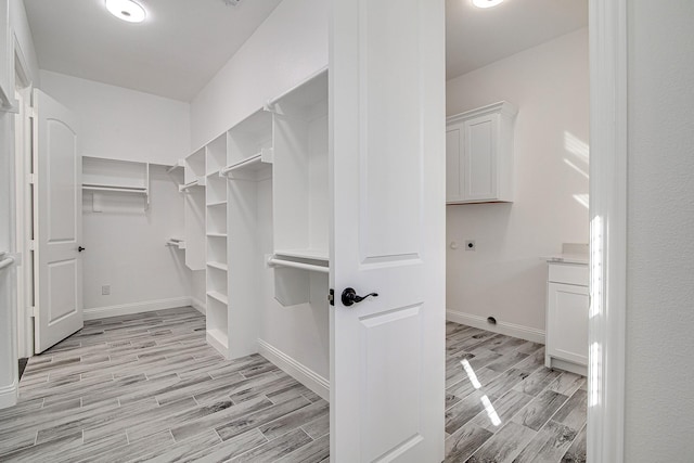 walk in closet featuring light hardwood / wood-style floors