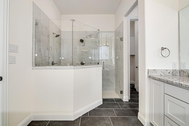 bathroom featuring an enclosed shower, vanity, and tile patterned flooring