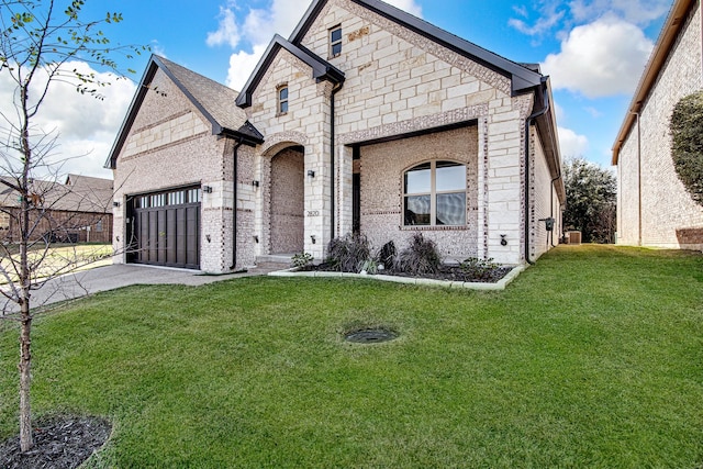 view of front of property featuring a garage and a front lawn