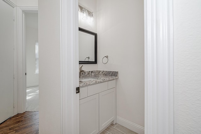 bathroom featuring vanity and hardwood / wood-style flooring