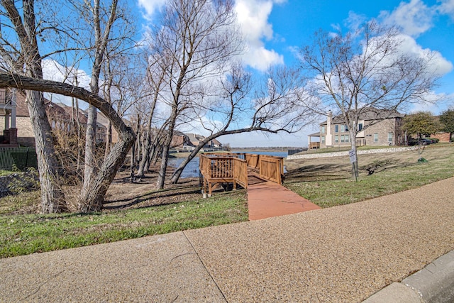 surrounding community with a deck with water view